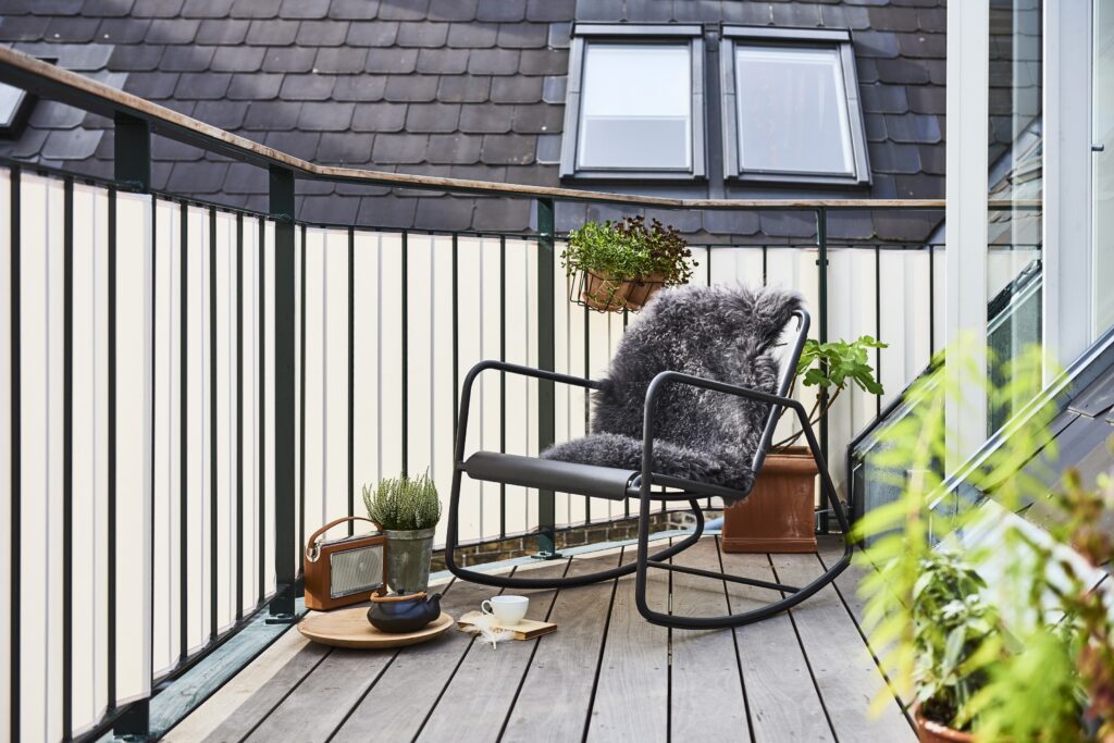 Copenhagen fotel bujany w czarnym kolorze na balkonie w miejskiej scenerii