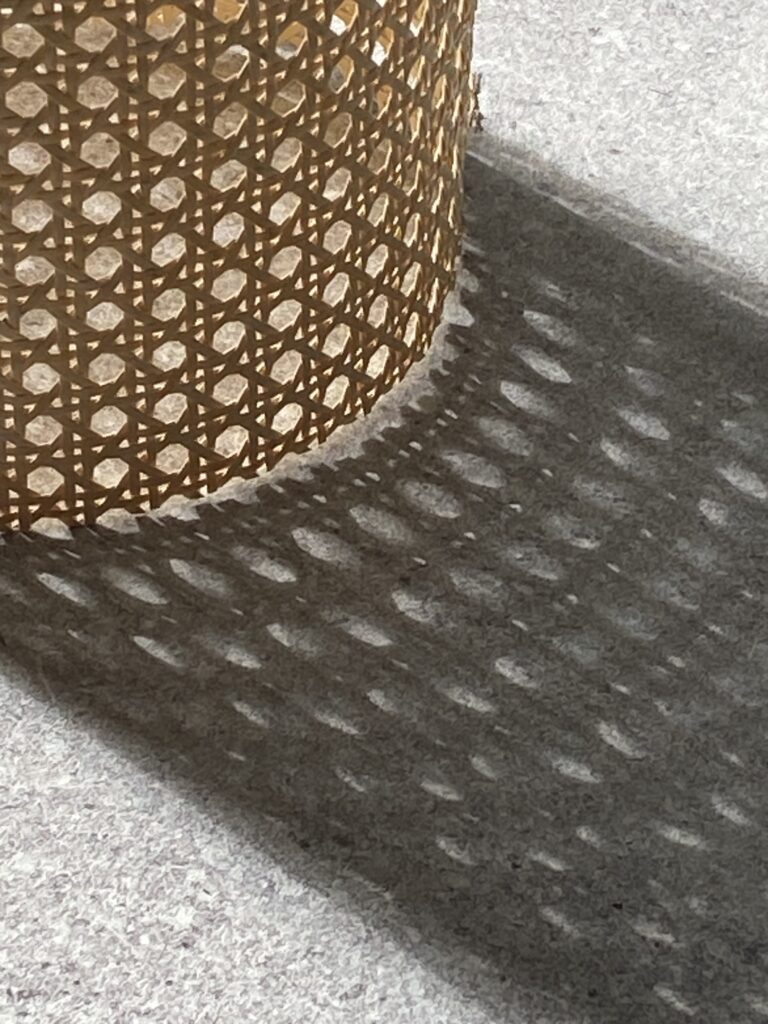 Zdjęcie plecionki wiedeńskie, która rzuca cień na szary blat stołu